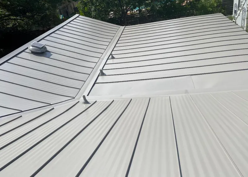 Solar attic fan installed on a metal roof for Roof Ventilation in Truth or Consequences